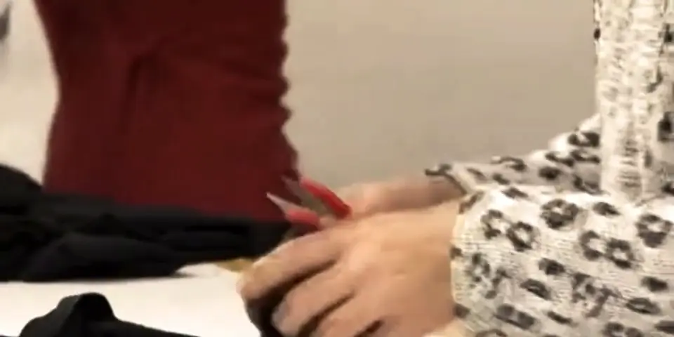 Trimming threads on a finished garment