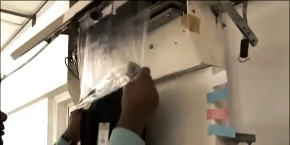 A finished garment going into a polybag