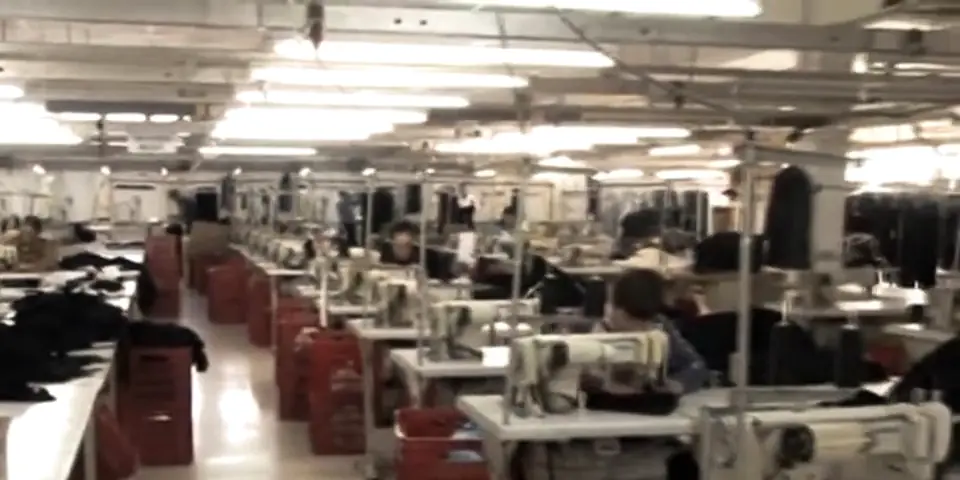 Sewing lines in the factory with red crates next to the machines