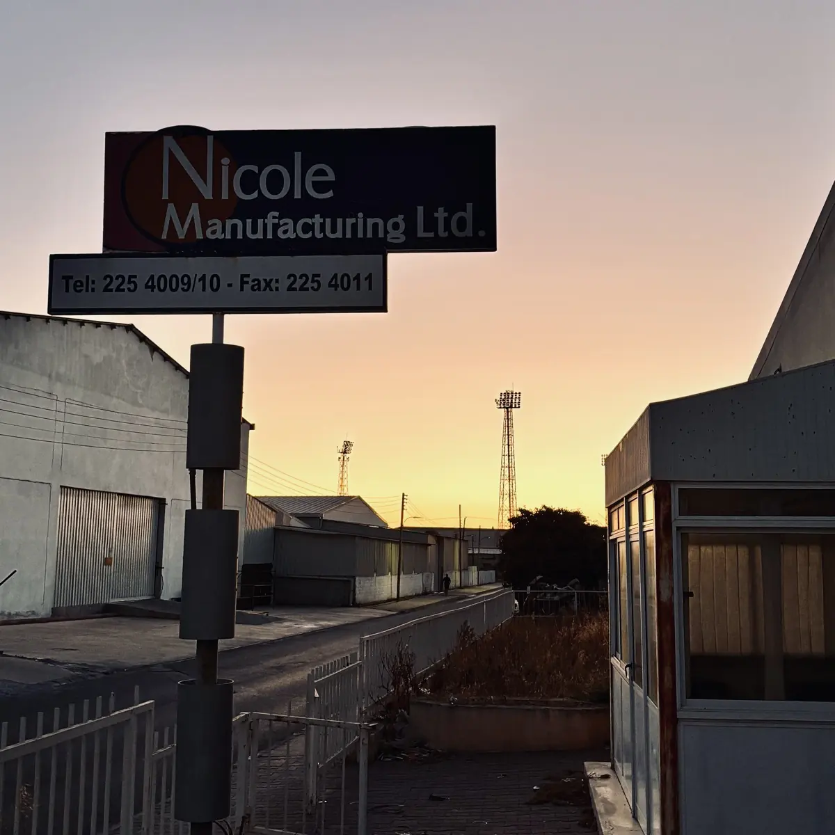 The Nicole Manufacturing sign on 4th Street at sunset